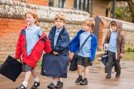 Children walking to school in winter weather