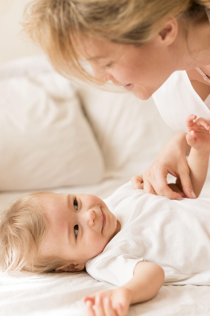 A baby being cared for by a nursery practitioner